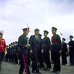 John Fitzgerald Kennedy, escorted by a Bermuda Militia Artillery officer, inspects a Bermuda Rifles guard in 1961, four years before the units amalgamated