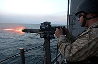 A 7.62 mm GAU-17 gatling gun of the U.S. Navy. It is an externally powered automatic machine gun. The electric motor that powers its loading, priming, and firing mechanics is on top. Also, note the spade grips and pintle mount.