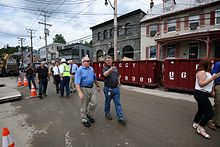 Governor of Maryland Larry Hogan tours Ellicott City, viewing damage left by the 2016 floods, accompanied by county executive Allan Kittleman. Governor Hogan Tours Old Ellicott City (28316091483).jpg