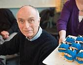 Lloyd Morrisett with a plate of Cookie Monster cupcakes, 2010