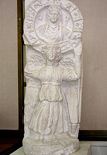 Nike holding up a bust of Atargatis, crowned as Tyche and encircled by the signs of the zodiac. Amman Museum copy of Nabataean statue, 100 AD. Nike with Zodiac (copy) Archaeological Museum Amman Citadel Jordan0820.jpg