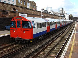A Bakerloo Line train departs Willesden Junction railway station, bound for Elephant and Castle. The trains are so low the platform is actually a step UP.