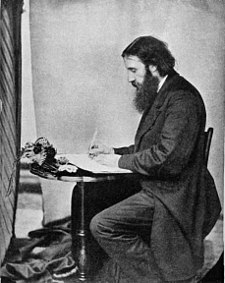 Image of the prolific author George MacDonald writing as a young man.