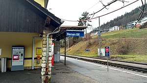 Building with overhang next to double-track railway line