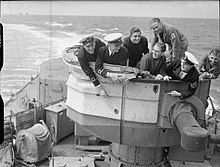 Splinter damage on the rear director tower of Sheffield caused by a near miss of the Bismarck. The Royal Navy during the Second World War A4092.jpg