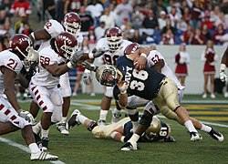 US Navy 081101-N-4936C-007 Navy midshipman Eric Kettani (no. 36) is tackled during a college football game between the U.S. Naval Academy and Temple University at Navy-Marine Corps Memorial Stadium in Annapolis, Md.jpg
