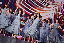 Members of Nogizaka46 performing on stage