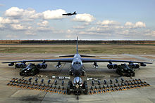 Boeing B-52H static display with weapons, Barksdale Air Force Base 2006. A second B-52H can be seen in flight in the background B-52H static display arms 06.jpg