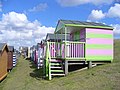 Colourful rows of wooden huts on the grassy slopes of "Tankerton slopes" below Marine Parade