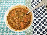Bowl of lentil soup with green and red lentils.