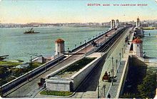 The new Cambridge (now Longfellow) Bridge pre-1912, viewed from the Boston end, with an unfinished heavy rail right-of-way down its center. Tracks visible at the sides are for streetcars. Cambridge Bridge postcard.jpg