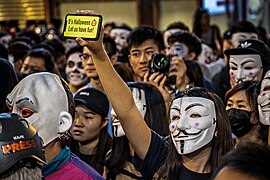 Protesters donning Guy Fawkes masks during Halloween 2019