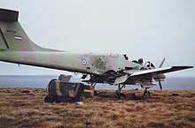 A destroyed "Pucara" at Pebble Island, 1982 Destroyed Argentine Pucara aircraft Pebble Island 1982.jpg