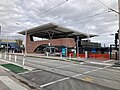 Station entrance and building from Glen Huntly Road and route 67 tram stop, October 2023