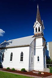 Photograph of a white church with a tall steeple