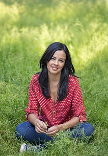 Liz Bonnin sitting in meadow 2 Credit Andrew Crowley.jpg