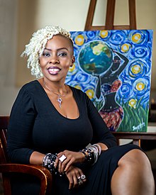 Sandra Mushi with one of her paintings