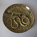 Wall plate, c.1900, coloured and mottled glazes in Palissy style.