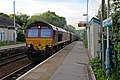 An EWS Class 66 passes through the station with a freight service.