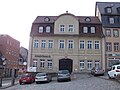 Wohnhaus in Ecklage in geschlossener Bebauung und drei Hintergebäude um einen Hof, davon ein Seitenflügel an der Friedrich-Engels-Straße, heute Stadthaus