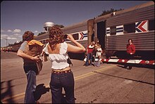 Passengers pose for a photo before boarding the Empire Builder in 1974. Amtrak trains traveling toward Chicago and Seattle stop daily between 1 and 4 am. Photo by Charles O'Rear. ONE LAST PHOTOGRAPH BEFORE PASSENGERS BOARD THE EMPIRE BUILDER AT FARGO, NORTH DAKOTA, ENROUTE FROM CHICAGO TO EAST... - NARA - 556091.jpg