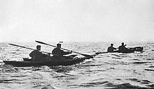 twotwoman canoes at sea