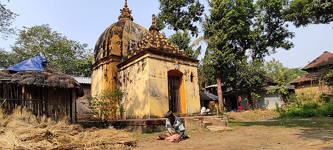 A man sitting idly in front of a temple at Chaurigram.