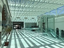 Post-renovation with the Atrium and accessibility lift added. University of Gibraltar Atrium.jpg