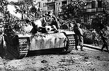 Soldiers ride a Sturmgeschutz III through the streets of Arnhem during Market Garden 9ss-StuG-III-Arnhem-2-copy-768x501.jpg