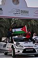 Alaa Rasheed raising the Jordanian flag in Dubai International Rally