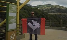 Bartosz Bekier holding a Falanga flag