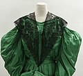 Black lace pelerine, green silk dress