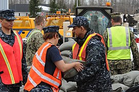 Members of the New York Naval Militia fill sandbags to aid in the preparations for possible flooding in the areas affected by a lake effect storm in the Buffalo, N.Y., region.