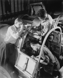 Three African-American workers complete the pilot's compartment of an aircraft, 1942 Final assembly of the pilot's compartment is being made by these Negro workers in a large eastern aircraft factory. The - NARA - 535810 - restored.png
