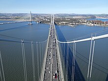 Traffic on Forth Road Bridge in Scotland prior to its opening to general traffic; traffic has now been moved to the Queensferry Crossing (on left) Forth from above.jpg