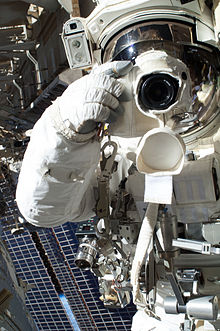 Astronaut Christopher Cassidy holding a camera while on EVA (Space-walk) ISS-36 EVA-3 (d) Chris Cassidy.jpg