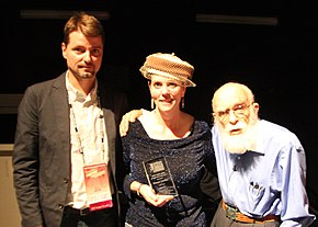 Gerbic, with D. J. Grothe (left) and James Randi (right), receives the James Randi Award for Skepticism in the Public Interest at The Amazing Meeting, July 2013 JREFGerbicTAMaward.jpg