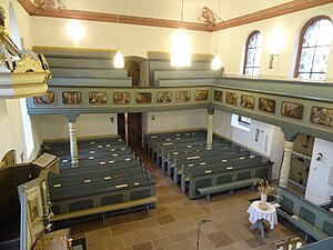 Daniel Hisgen's paintings are mostly cycles on the parapets of Lutheran church galleries. Here the Creation (left) to the Annunciation can be seen. St. Michaelis Oberkleen Blick nach Westen 02.JPG