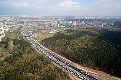 The Moscow Automobile Ring Road (MKAD) divides the former municipal districts of Vykhino (left) and Zhulebino (right). In the photo, there is Zhulebinskiy Zakaznik [ru] to the right of the MKAD.