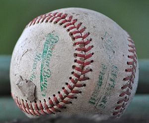 English: A baseball that has been extensively used