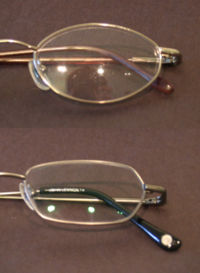Uncoated glasses lens (top) versus lens with anti-reflective coating. The reflection from the coated lens is tinted because the coating works better at some wavelengths than others. Anti-reflective coating comparison.jpg
