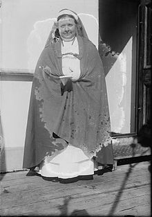 Woman singing in a cassock