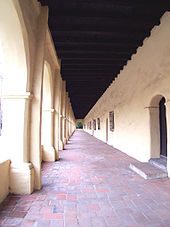 1797 Mission San Fernando Rey de Espana: View looking down an exterior arcade or corredor, an element frequently used in Mission Revival design. Exterior Corridor at San Fernando Rey de Espana.jpg