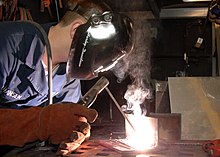Shielded metal arc welding US Navy 090114-N-9704L-004 Hull Technician Fireman John Hansen lays beads for welding qualifications.jpg
