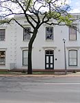 The original part of this double-storeyed town house dates from the beginning of the 19th century. The building was later adapted to the Georgian style. The property forms an essential part of the traditional architectural street scene of Dorp Street, and thus also of the historic core of Stellenbosch.