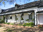 These two Victorianised houses, which were originally erected during the first half of the 19th century, together with six other similar buildings, form one of the most charming and harmonious street scenes in Stellenbosch.