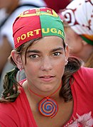 A girl wearing a bandana on her head to support Portugal in football in the colors of that country's flag
