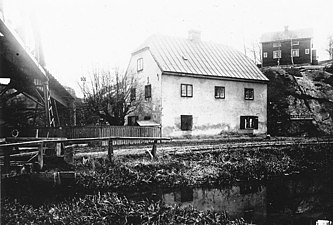 Kvarnbyggnaden och mjölnarstugan upp till höger, 1906.