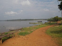 A large lake with a path on the foreshore