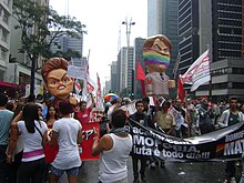 Gay Pride in Sao Paulo. The LGBT-related magazine The Advocate has called Jair Bolsonaro "Brazil's biggest homophobe". Parada gay 2011 - bonecos dilma e bolsonaro.jpg